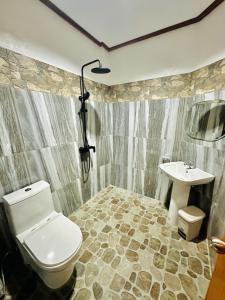 a bathroom with a toilet and a sink at El Nido Viewdeck Cottages in El Nido