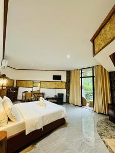 a bedroom with a large white bed in a room at El Nido Viewdeck Cottages in El Nido