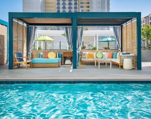 a patio with a pool and chairs and a table at Margaritaville Hotel San Diego Gaslamp Quarter in San Diego