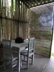 a wooden table and two chairs on a patio at Rancho Blue in Marau