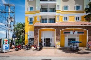 a group of motorcycles parked in front of a building at Nam Talay Condo by GrandisVillas in Na Jomtien