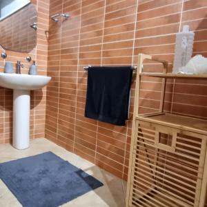 a bathroom with a sink and a blue towel at Cside Escape Villa in Rivière Noire +17 photos