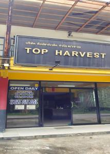 ein Top-Erntezeichen auf der Vorderseite eines Ladens in der Unterkunft Top Harvest Rental in Baan Tai