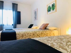 a hotel room with two beds and a window at Posada de la Judería III in Córdoba