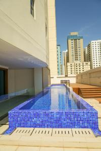 a swimming pool on the roof of a building at Modern Heights in Juffair