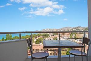 a balcony with a table and chairs and a view at Blue Sea Hotel & Spa in Kuşadası