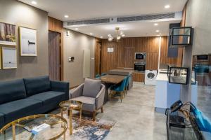 a living room with a couch and a table at Modern Heights in Juffair