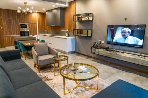 a living room with a couch and a tv at Modern Heights in Juffair