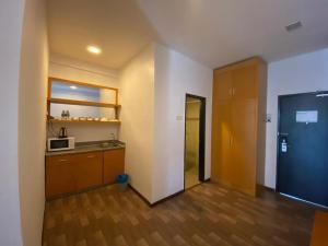 an empty room with a kitchen with a microwave at Hills Aranda Nova Hotel in Cameron Highlands