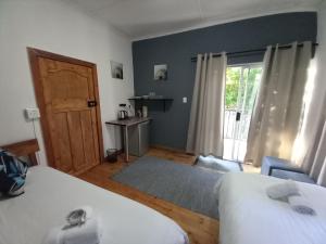 Postel nebo postele na pokoji v ubytování 7 On Grey Guesthouse