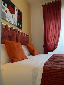 a bedroom with a bed with red curtains at Beside the Vatican in Rome