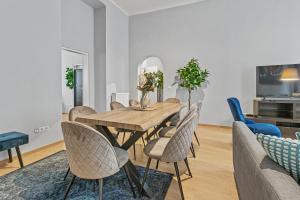 a dining room with a wooden table and chairs at 5 Bedrooms - 143 m² - Near Main Station in Vienna