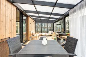 a dining room with a table and chairs at Villa Pickala - Design - Seafront - Hot tub in Helsinki