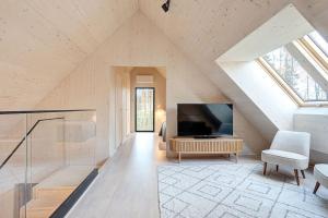 a living room with a large window and a tv at Villa Pickala - Design - Seafront - Hot tub in Helsinki
