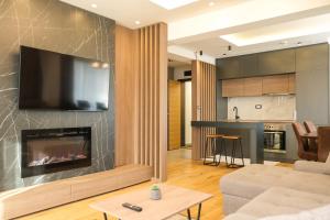 a living room with a couch and a fireplace at Vila Golija in Kopaonik