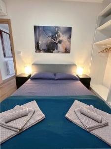 a bedroom with a bed with two towels on it at In Mezzo All'Aria Apartment in Mezzolara