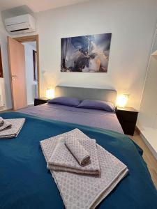 a hotel room with a bed with towels on it at In Mezzo All'Aria Apartment in Mezzolara