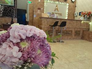 a bunch of pink flowers sitting in a room at A25 Hotel - 15 Hàng Than in Hanoi