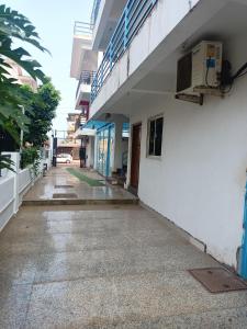 an empty hallway of a building with a sidewalk at Sai Leela Guest House in Dabolim