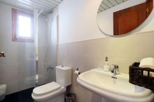 La salle de bains est pourvue de toilettes, d'un lavabo et d'un miroir. dans l'établissement Posada Almanzor, à Cordoue