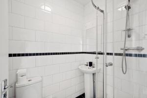 a bathroom with a shower and a toilet and a sink at Boutique Apartments in Central Bristol in Bristol