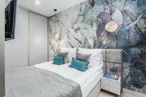 Posteľ alebo postele v izbe v ubytovaní Apartamenty DEO PLAZA by Rent like home