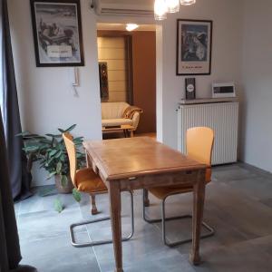 a dining room with a wooden table and chairs at Home Away in Blankenberge