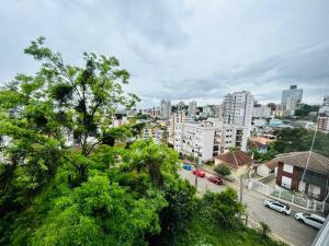 a view of a city with buildings and trees at Apartamento em Bento Gonçalves in Bento Gonçalves