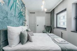 Posteľ alebo postele v izbe v ubytovaní Apartamenty DEO PLAZA by Rent like home