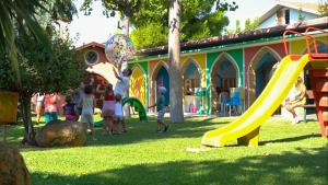 Villaggio Welcome Riviera d'Abruzzo في تورتوريتو ليدو: مجموعة من الأطفال يلعبون في ملعب