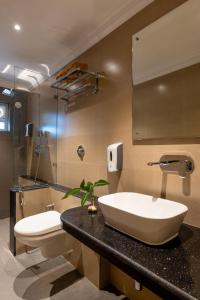 a bathroom with a large sink and a toilet at La Ben Resort in Colva