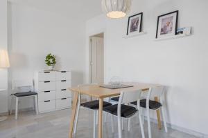 uma sala de jantar com uma mesa de madeira e cadeiras em Easy apartment in Fuengirola Downtown - Ref 28 em Fuengirola