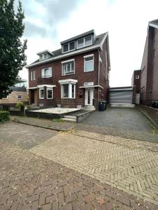 a brick house with a driveway in front of it at Luxurious House in Kerkrade Center in Kerkrade