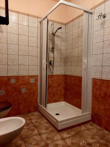 a shower in a bathroom with a toilet and a sink at B&B Mannalà in Agrigento