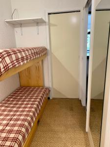 a small bedroom with a bunk bed and a closet at Studio montagne gentianes in Isola 2000