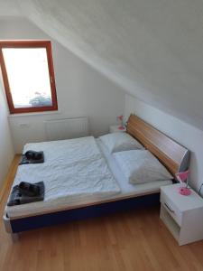 a bedroom with a bed and a window at Apartma Julia in Spodnje Gorje