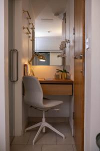 a desk with a chair in a room at The Luxury Inn in London