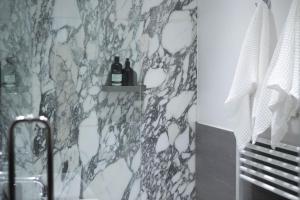 a bathroom with two bottles of wine on a wall at The Luxury Inn in London