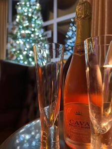 a bottle of champagne and two glasses on a table at Raffles Hotel in Blackpool