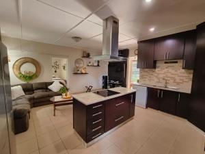 a kitchen and living room with a couch at Sea La Vie in Richards Bay