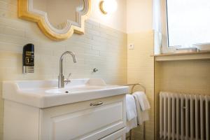 a bathroom with a sink and a mirror at Heger Tor Apartments in Osnabrück +47 photos