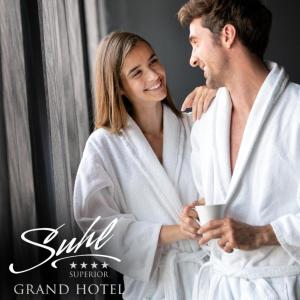 ズールにあるHVD Grand Hotel Suhl Business & Leisureのバスタオルを着た男女