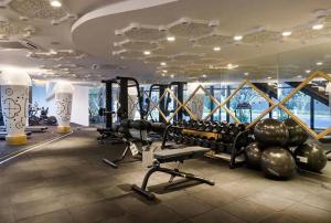 a gym with tread machines and a large window at Arte Mont Kiara Cozy 1BR Suites in Kuala Lumpur