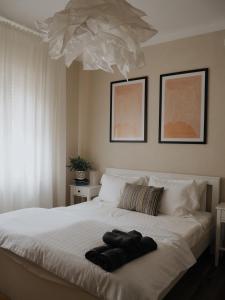 a bedroom with a white bed with two towels on it at Verte House in Alba Iulia +37 photos