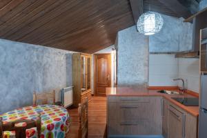 a kitchen with a bed and a sink in it at Posada La Olma in Polientes