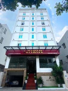 a hotel with a red sign in front of a building at A25 Hotel -137 Nguyễn Du - Đà Nẵng in Danang