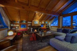 a living room with a couch and a fireplace at Chalet Les Solans in Les Allues