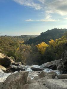 a river with rocks and trees in the background at Casa rural Aloha Vera in Jarandilla de la Vera