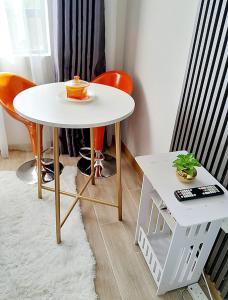a white table and two chairs and a table with a cup on it at Polar homes in Nairobi +14 photos