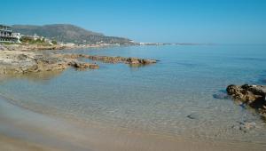 a view of a beach with rocks in the water at W Suites by Estia ex Camelot in Malia +61 photos